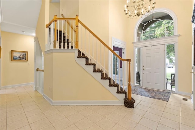 22614 W 46th Ter, Shawnee, KS 66226 - tiled entrance foyer featuring a chandelier, a towering ceiling, stairway, and baseboards