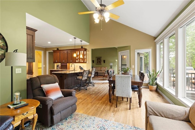 22614 W 46th Ter, Shawnee, KS 66226 - dining area with light wood-style floors, a ceiling fan, and high vaulted ceiling