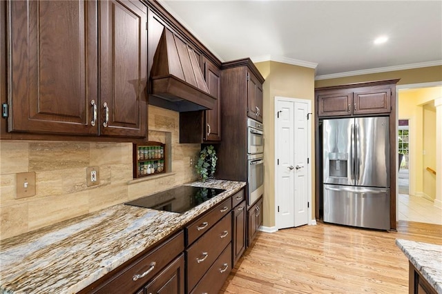 22614 W 46th Ter, Shawnee, KS 66226 - kitchen featuring appliances with stainless steel finishes, premium range hood, crown molding, tasteful backsplash, and light stone counters