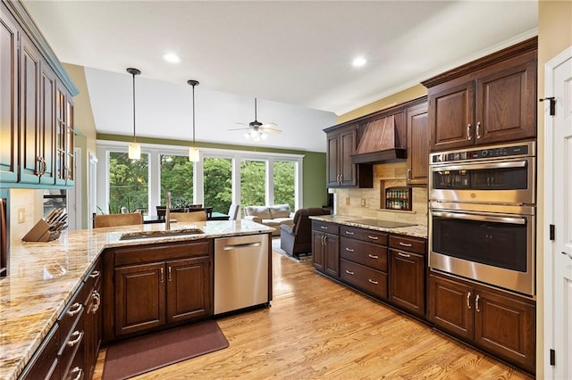 22614 W 46th Ter, Shawnee, KS 66226 - kitchen featuring appliances with stainless steel finishes, ceiling fan, a sink, light wood-style flooring, and dark brown cabinetry