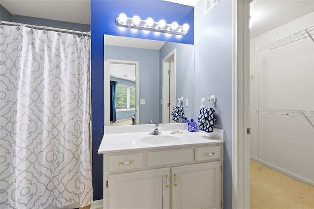 22614 W 46th Ter, Shawnee, KS 66226 - full bath with vanity, a walk in closet, and a shower with curtain