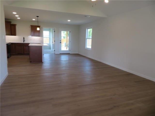 902 2nd St, Perry, KS 66073 - unfurnished living room featuring wood finished floors, baseboards, and recessed lighting