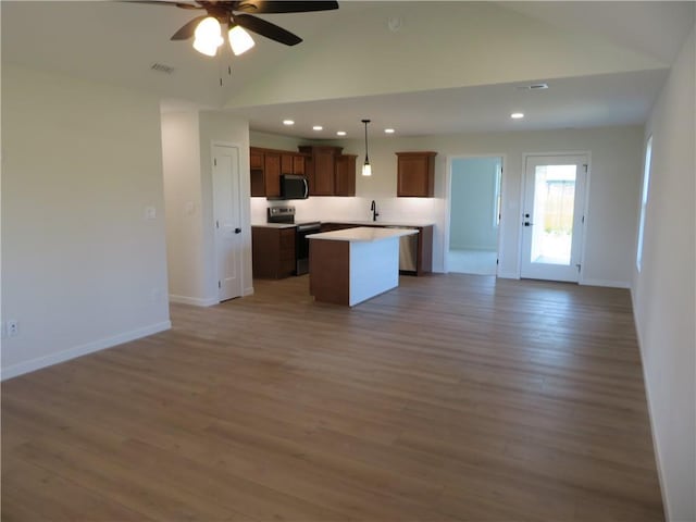 902 2nd St, Perry, KS 66073 - kitchen with appliances with stainless steel finishes, open floor plan, a kitchen island, a ceiling fan, and a sink