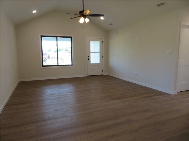 902 2nd St, Perry, KS 66073 - unfurnished living room with ceiling fan, dark wood-type flooring, lofted ceiling, baseboards, and recessed lighting