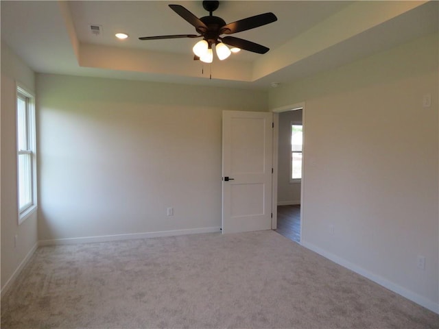 902 2nd St, Perry, KS 66073 - unfurnished room with a raised ceiling, carpet, baseboards, ceiling fan, and recessed lighting
