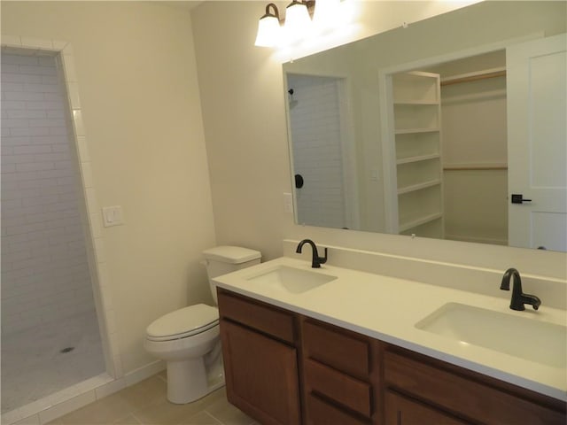 902 2nd St, Perry, KS 66073 - full bathroom featuring toilet, double vanity, tiled shower, and tile patterned flooring