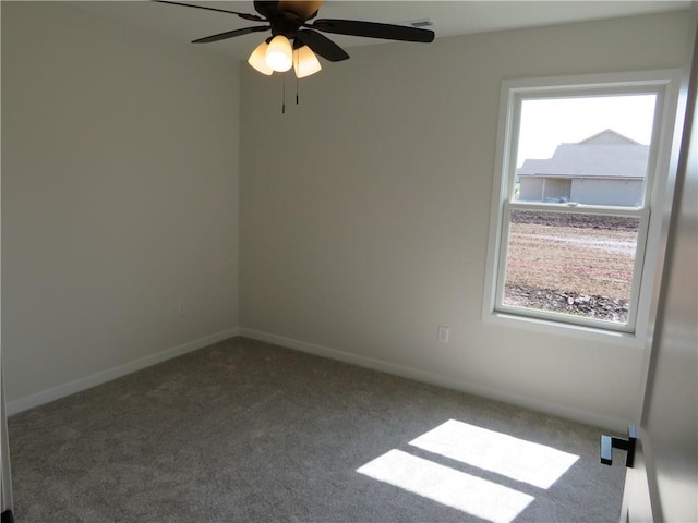 902 2nd St, Perry, KS 66073 - empty room with carpet flooring, plenty of natural light, a ceiling fan, and baseboards