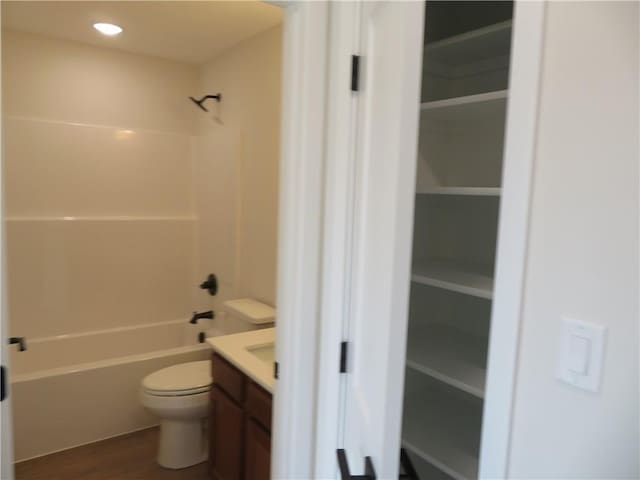 902 2nd St, Perry, KS 66073 - full bathroom featuring vanity, toilet, bathtub / shower combination, and wood finished floors