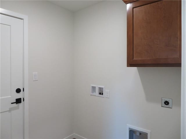 902 2nd St, Perry, KS 66073 - laundry room featuring cabinet space, electric dryer hookup, hookup for a washing machine, and baseboards