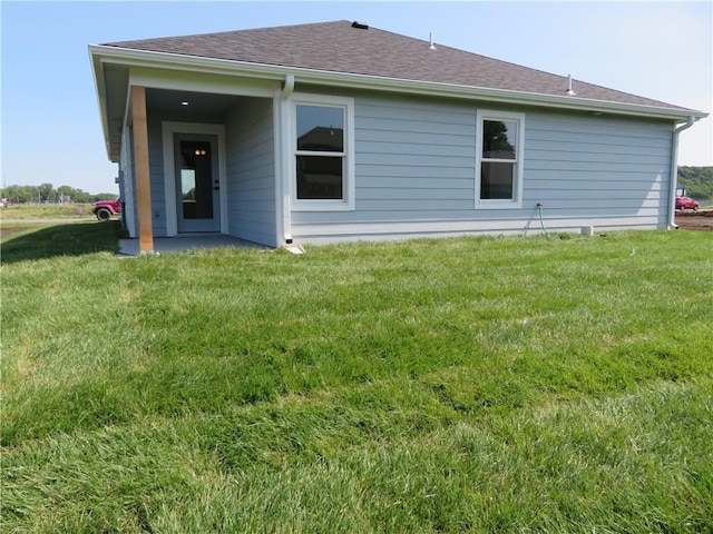 902 2nd St, Perry, KS 66073 - rear view of house featuring a yard and roof with shingles