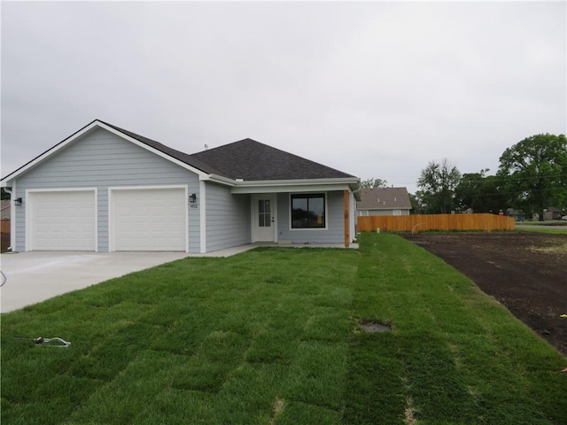 902 2nd St, Perry, KS 66073 - ranch-style house with concrete driveway, an attached garage, and a shingled roof