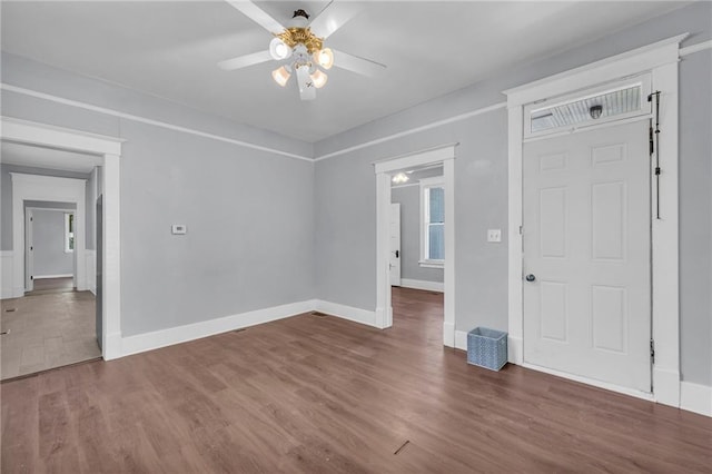1010 N 13th St, Leavenworth, KS 66048 - unfurnished room featuring wood finished floors, a ceiling fan, and baseboards