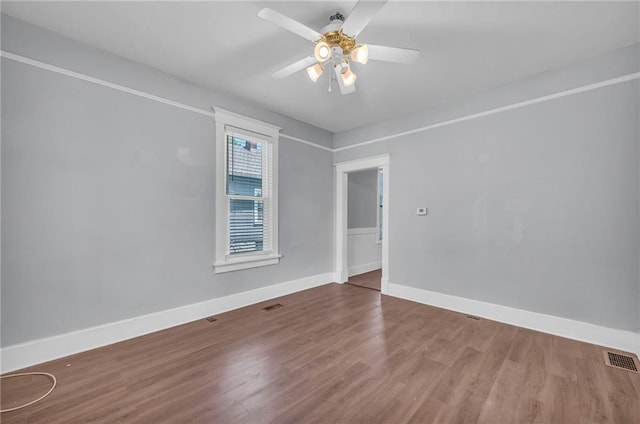 1010 N 13th St, Leavenworth, KS 66048 - empty room with wood finished floors, baseboards, and ceiling fan