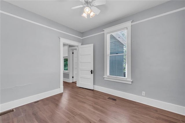 1010 N 13th St, Leavenworth, KS 66048 - unfurnished room with plenty of natural light, baseboards, wood finished floors, and ceiling fan