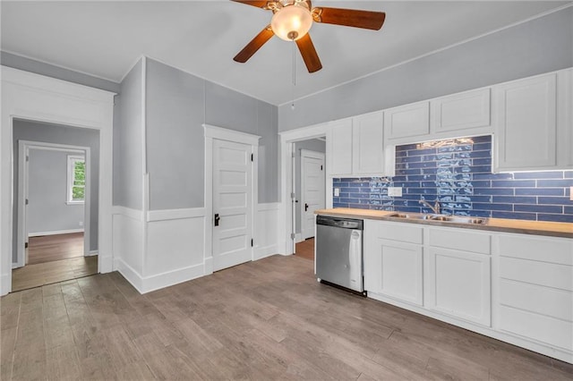 1010 N 13th St, Leavenworth, KS 66048 - kitchen with dishwasher, a sink, ceiling fan, light wood finished floors, and backsplash