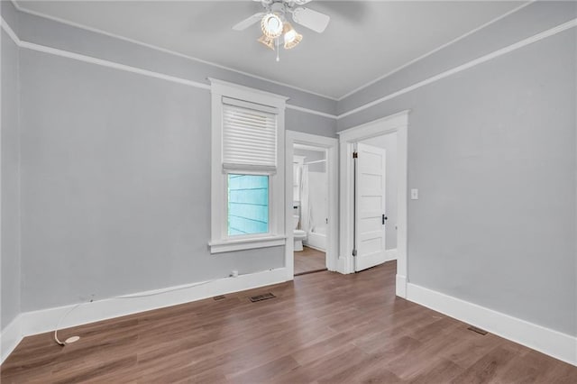 1010 N 13th St, Leavenworth, KS 66048 - unfurnished room with ceiling fan, wood finished floors, and baseboards