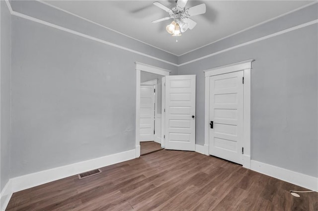 1010 N 13th St, Leavenworth, KS 66048 - unfurnished bedroom featuring wood finished floors, baseboards, and ceiling fan