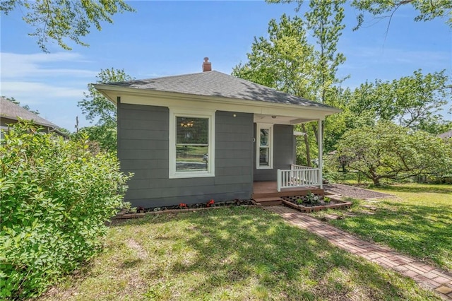 1010 N 13th St, Leavenworth, KS 66048 - bungalow-style home with a chimney, a front yard, a porch, and a shingled roof