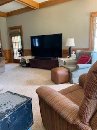 living room with wainscoting, beam ceiling, and carpet floors