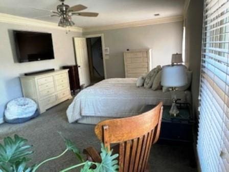 bedroom featuring crown molding, carpet floors, and a ceiling fan