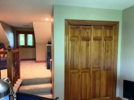 hall with baseboards and carpet flooring