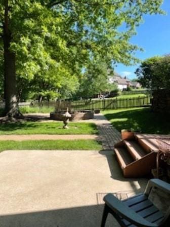 surrounding community with fence and a patio
