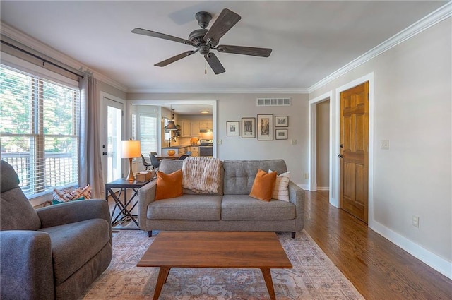 2007 NE Newport Ct, Blue Springs, MO 64014 - living room featuring wood finished floors, crown molding, a ceiling fan, and baseboards