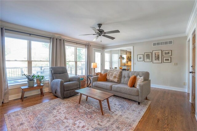 2007 NE Newport Ct, Blue Springs, MO 64014 - living area featuring crown molding, ceiling fan, baseboards, and wood finished floors