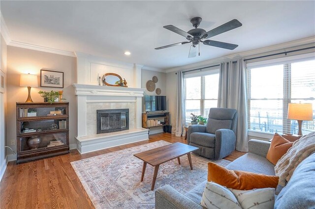 2007 NE Newport Ct, Blue Springs, MO 64014 - living room with crown molding, a tiled fireplace, wood finished floors, and a ceiling fan