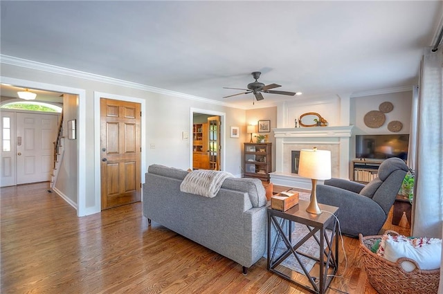 2007 NE Newport Ct, Blue Springs, MO 64014 - living area with wood finished floors, crown molding, ceiling fan, a high end fireplace, and baseboards