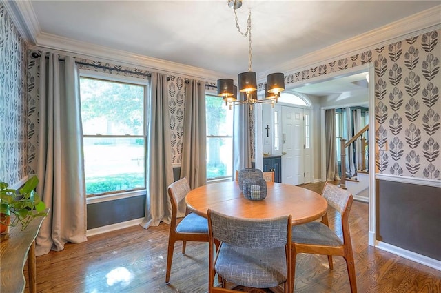 2007 NE Newport Ct, Blue Springs, MO 64014 - dining space with wallpapered walls, a chandelier, baseboards, crown molding, and wood finished floors
