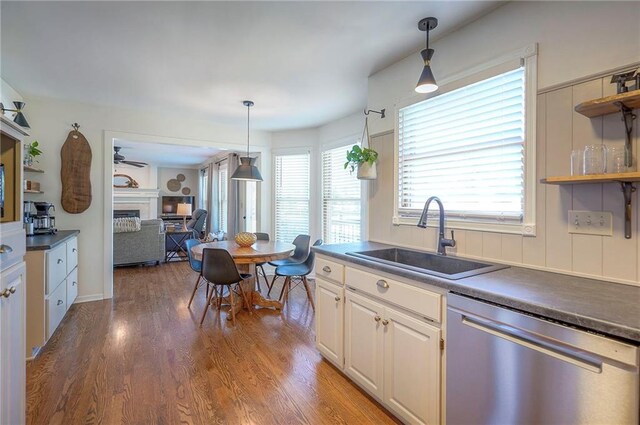 2007 NE Newport Ct, Blue Springs, MO 64014 - kitchen with dishwasher, a sink, a fireplace, open shelves, and dark countertops