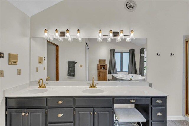 2007 NE Newport Ct, Blue Springs, MO 64014 - full bath with double vanity, lofted ceiling, and an enclosed shower