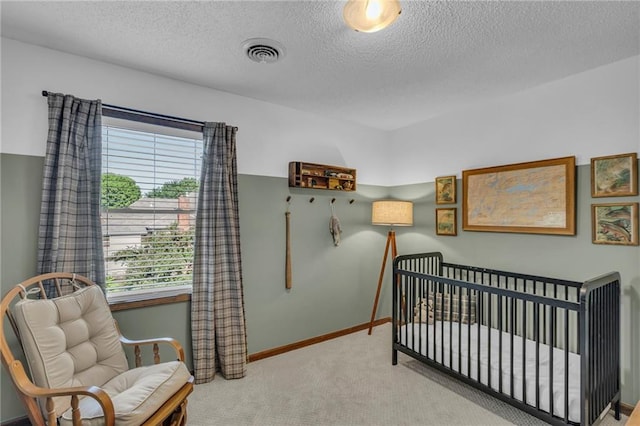 2007 NE Newport Ct, Blue Springs, MO 64014 - carpeted bedroom featuring multiple windows, a textured ceiling, baseboards, and a nursery area