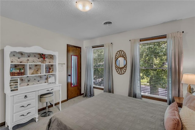 2007 NE Newport Ct, Blue Springs, MO 64014 - bedroom featuring light colored carpet, a textured ceiling, baseboards, and a desk