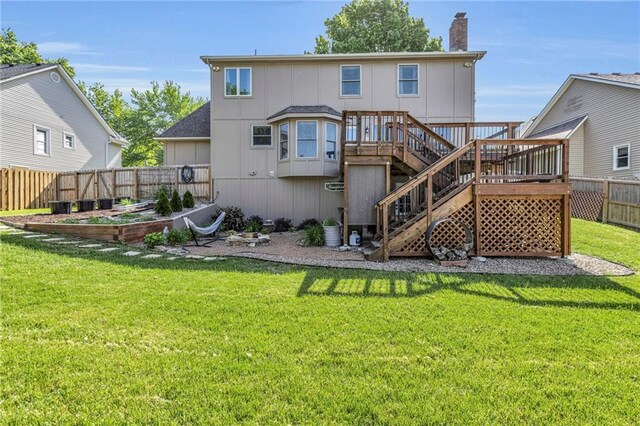 2007 NE Newport Ct, Blue Springs, MO 64014 - back of house with a vegetable garden, a chimney, a wooden deck, and stairway