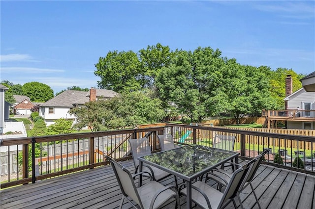 2007 NE Newport Ct, Blue Springs, MO 64014 - wooden deck with outdoor dining space and a fenced backyard