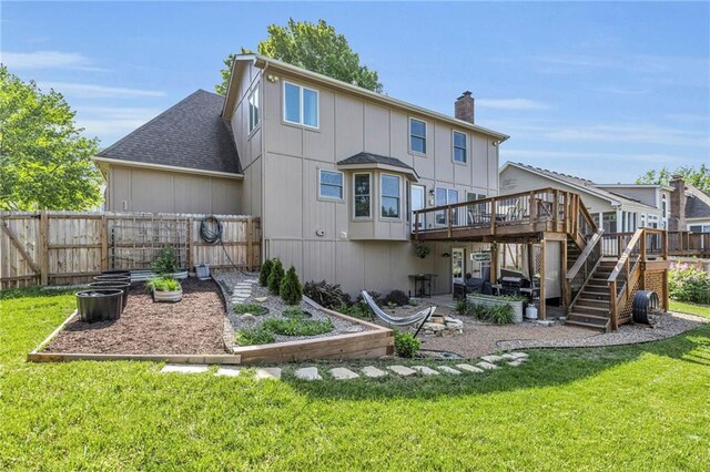 2007 NE Newport Ct, Blue Springs, MO 64014 - rear view of house featuring a garden, a wooden deck, a chimney, stairs, and roof with shingles