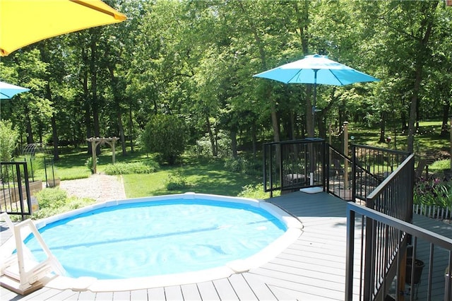 1658 NW 785th Rd, Bates City, MO 64011 - swimming pool with a wooden deck, a yard, and view of wooded area