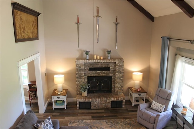 1658 NW 785th Rd, Bates City, MO 64011 - living room featuring high vaulted ceiling, wood finished floors, beam ceiling, a brick fireplace, and baseboards