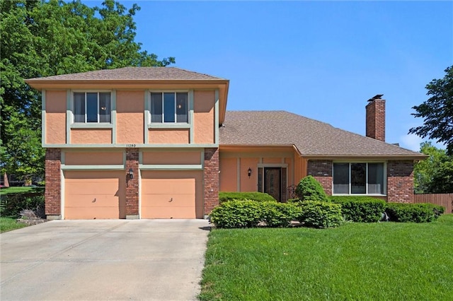 view of front of property with driveway, a chimney, an attached garage, and brick siding