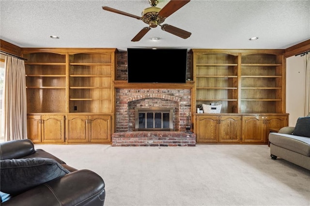 living area with a textured ceiling, light colored carpet, a ceiling fan, a fireplace, and recessed lighting