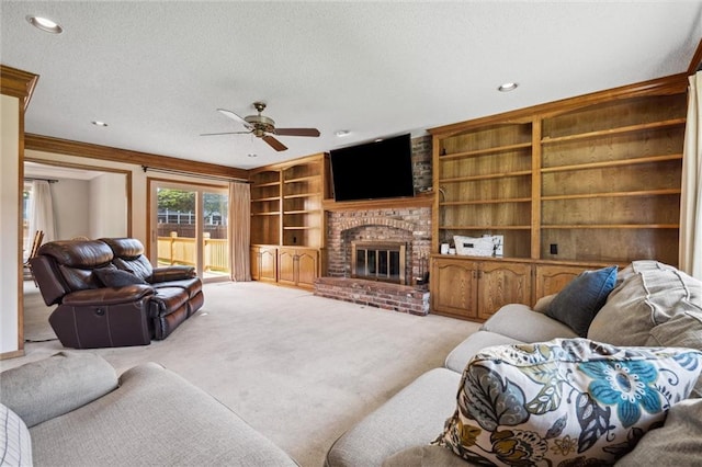 living room with a textured ceiling, ceiling fan, carpet flooring, a fireplace, and built in features