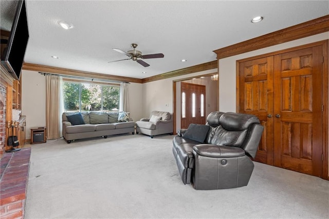 living area featuring carpet, ornamental molding, a ceiling fan, and recessed lighting