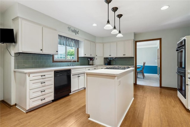 kitchen with black appliances, light countertops, white cabinetry, light wood finished floors, and recessed lighting