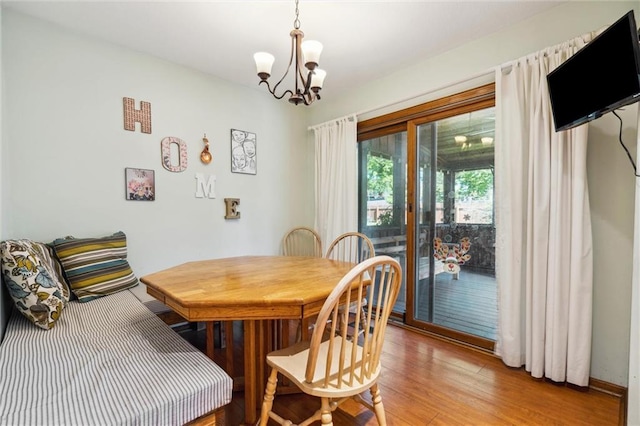 dining space featuring a chandelier and light wood finished floors