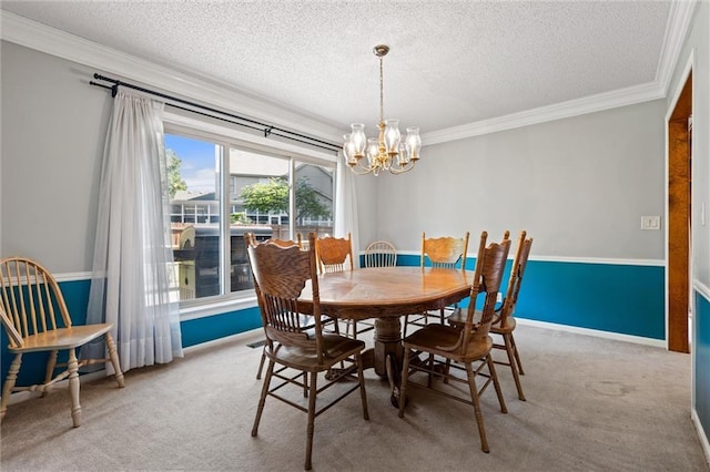 carpeted dining room featuring a chandelier, crown molding, a textured ceiling, and baseboards