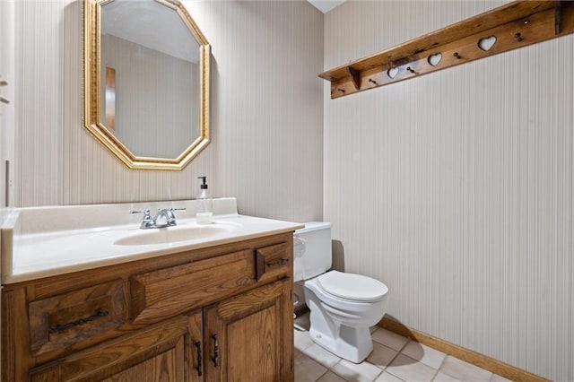 bathroom featuring wallpapered walls, toilet, vanity, and tile patterned flooring