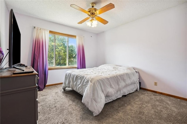 bedroom featuring carpet floors, baseboards, a textured ceiling, and a ceiling fan