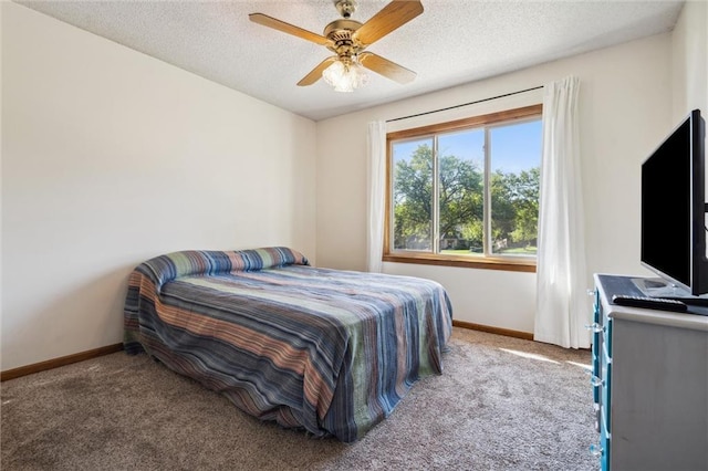 carpeted bedroom with baseboards, a ceiling fan, and a textured ceiling